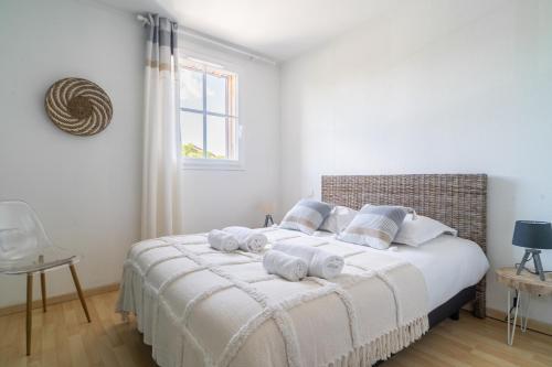 1 dormitorio con 1 cama con toallas en LES RENARDS - Charmante petite maison au port de la Teste, en La Teste-de-Buch
