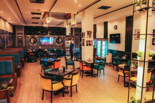 a dining room with tables and chairs in a restaurant at Aracan Portsaid in Port Said