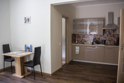 a small kitchen with a table and chairs in a room at Villa Pirken Hammer in Pirkenhammer