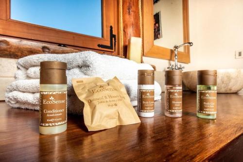 a group of four products sitting on a wooden table at Hill & Sky Lodge in Pucón