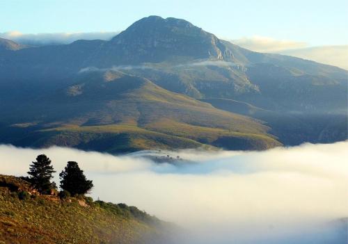 a view of a mountain with clouds in the valley at Akasha Mountain Retreat, new location in Heidelberg