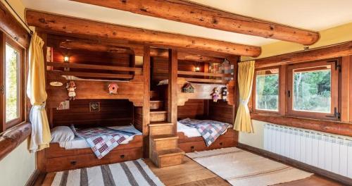 a room with two bunk beds in a cabin at Hill & Sky Lodge in Pucón