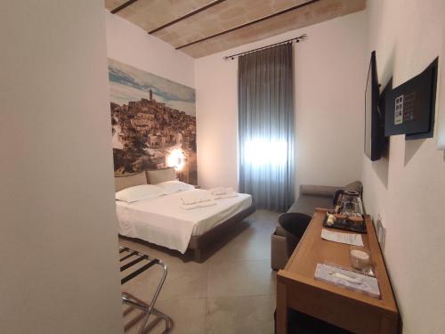 a hotel room with a bed and a couch at La Lupa in Matera