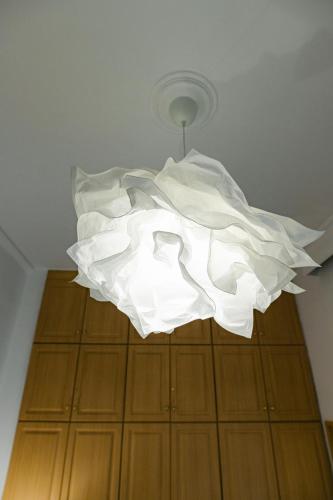 a large white light hanging from a ceiling at Flat 126 in Alexandroupoli
