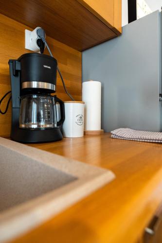 a coffee maker and a cup on a counter at Flat 126 in Alexandroupoli