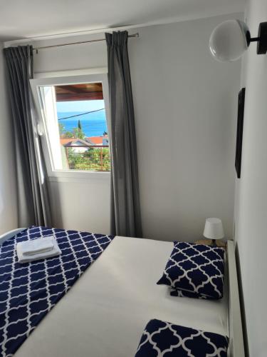 a bedroom with a bed with a window at Selce Holiday in Selce
