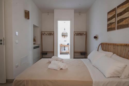 a bedroom with a bed with two pillows on it at Dimorae Camà in Cisternino