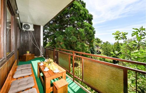 a balcony with a wooden table and benches on it at Lovely Home In Gornja Reka With Wifi in Lokošin Dol