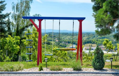 a swing in a park with blue and red poles at Lovely Home In Gornja Reka With Wifi in Lokošin Dol