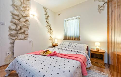 a bedroom with a bed with bananas on it at Lovely Home In Gornja Reka With Wifi in Lokošin Dol