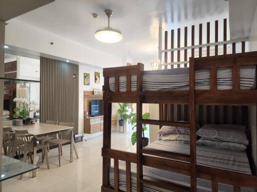 a room with a bunk bed and a dining room at Myna A in Nasugbu