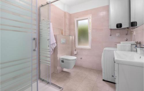 a pink bathroom with a toilet and a sink at Awesome Apartment In Tribalj With Kitchen in Tribalj