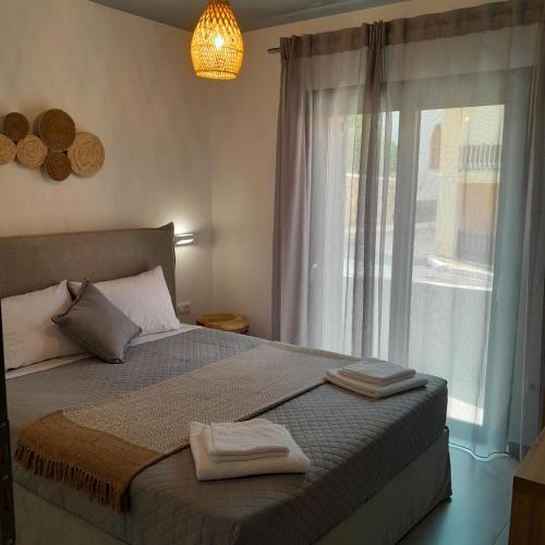 a bedroom with a bed with two towels on it at Brand new flat near de bosset bridge, Argostoli in Argostoli