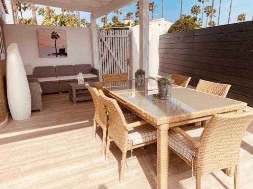 a dining table and chairs on a patio at SUITE COCO in Maspalomas