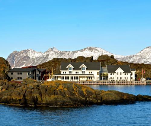 a large house on a rocky island in the water at Hamn i Senja in Hamn