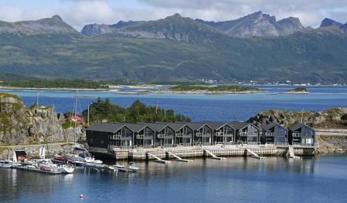 a marina with houses and boats in the water at Hamn i Senja in Hamn