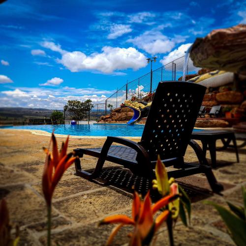 a black chair sitting next to a water park at Hotel Las Rocas Resort Villanueva in Villanueva