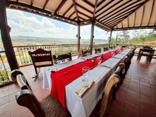 a long table with wine glasses on it with a view at Hotel Las Rocas Resort Villanueva in Villanueva