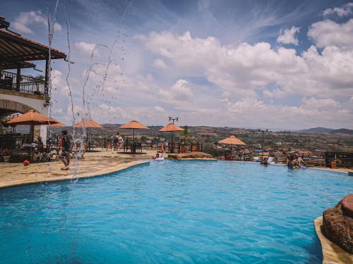 a large swimming pool with a view of a city at Hotel Las Rocas Resort Villanueva in Villanueva
