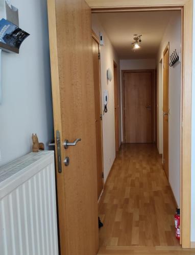 a hallway with a door leading to a room with a hallway at Appartement De Wal in Tongeren