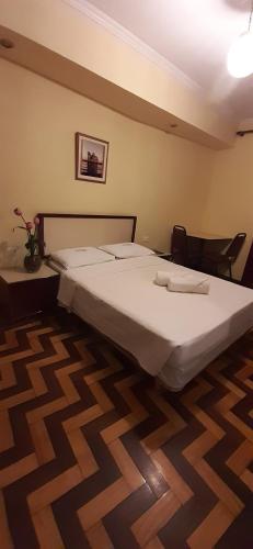 a bedroom with a large bed in a room at Itajubá Hotel in Rio de Janeiro