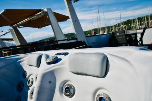 a white boat sitting on a boat in the water at mariTIME deluxe in Portorož