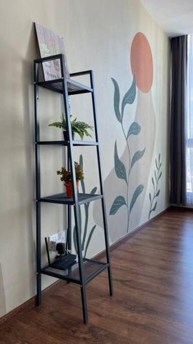 a shelf with plants in a room with a wall at #1.3 Cozy 7Pax Large Beds 2B1R Vivacity Kuching Jazz Suites in Kuching