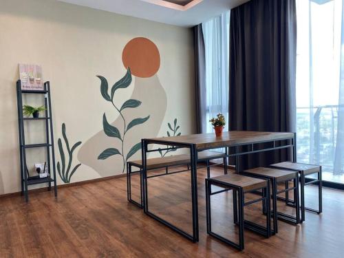 a dining room with a table and chairs and a wall at #1.3 Cozy 7Pax Large Beds 2B1R Vivacity Kuching Jazz Suites in Kuching