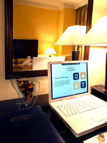 a laptop computer sitting on a desk in a hotel room at Toledo Amman Hotel in Amman