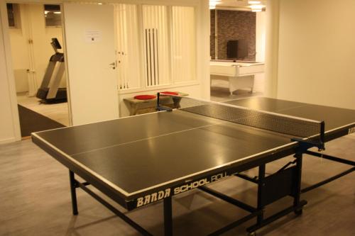 a ping pong table in the middle of a room at Hotell Lyktan in Arjeplog