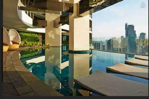 a swimming pool with a view of the city at 1 Bedroom Flat in Gramercy Residences Condo in Manila