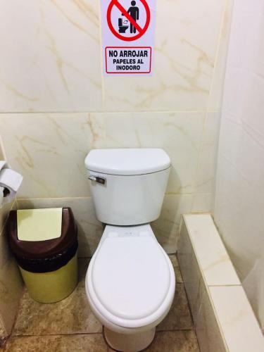 a bathroom with a toilet and a no smoking sign at KORICANCHA in Lima