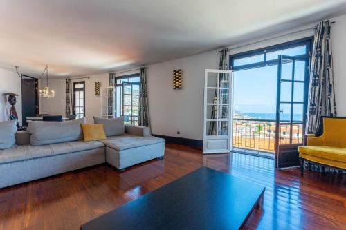 a living room with a couch and a table at FLH Funchal Artistic Apartment with Balcony in Funchal