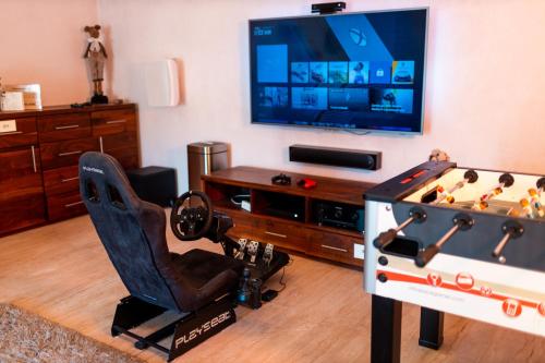 a living room with a game console and a table with a chessboard at Willa pod Czantorią SPA Ustroń in Ustroń