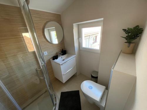 a bathroom with a shower and a toilet and a sink at Nice Renting - FERSEN - 2 Rooms Vieil Antibes - AC - Safranier - Big Terrace in Antibes