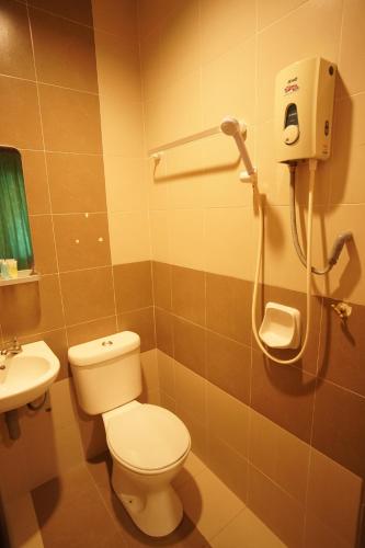 La salle de bains est pourvue de toilettes et d'un lavabo. dans l'établissement V HOTEL, à Teluk Intan