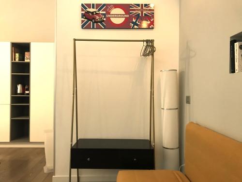 a white refrigerator in a room with a shelf at CaseOspitali - Casa Raffaella, moderno bilocale vicino al San Raffaele in Segrate