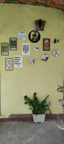 a wall with a bunch of signs on it at Pousada Nordestina in Recife