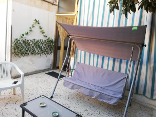 a chair and a table on a balcony at Alle Falde di Erice in Trapani