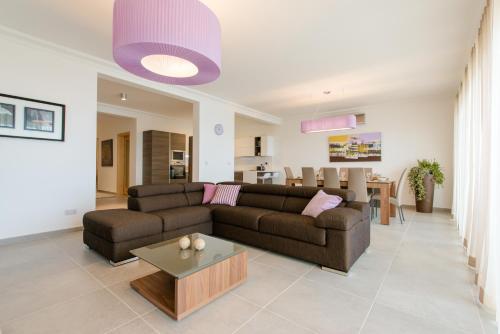 a living room with a couch and a table at Seafront Apartment Sliema in Sliema