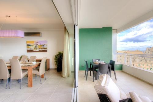 a dining room with a table and chairs at Seafront Apartment Sliema in Sliema