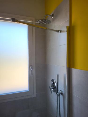 a bathroom with a shower with a window at Casa Villaggio Pirandello in Agrigento