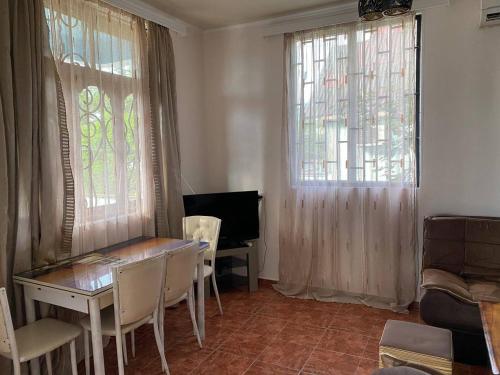 a dining room with a table and two windows at Holiday Home in Gonio in Gonio