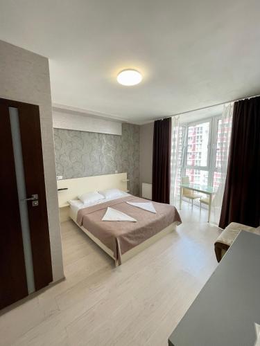 a bedroom with a large bed and a window at East Residence in Kyiv