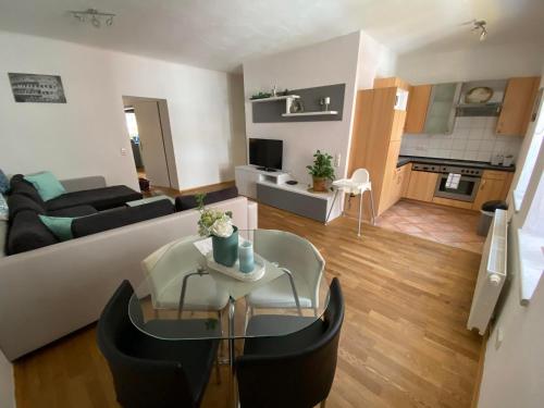 a living room with a couch and a table at Apartsee Zell am See in Zell am See