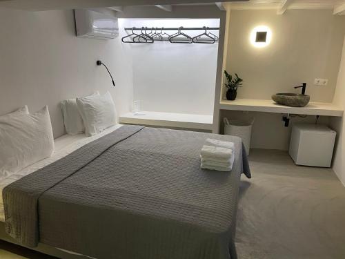 a bedroom with a large bed with towels on it at Rania Apartments Sea View in Mýkonos City