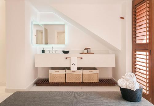 a bathroom with a sink and a mirror at El Careyes Club & Residences in Careyes