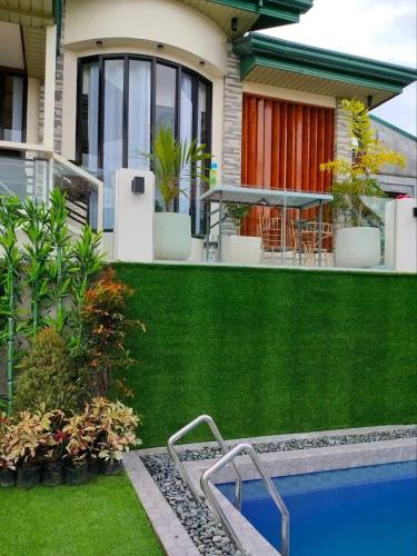 a house with a swimming pool in the yard at Palompon kalimba de luna Villa Inn in Leyte