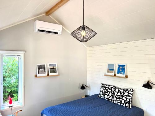 a bedroom with a blue bed and a window at Bittes & Lasses Guest House in Kalmar