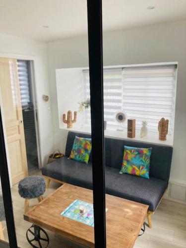 a living room with a couch and a table at La p’tite maison de locqui in Locquirec
